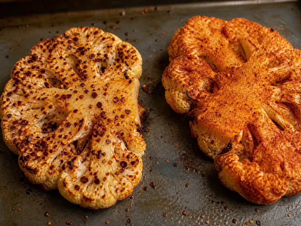 Coarse ancho chile and fine cayenne rubs on two roasting surfaces - Aleppo pepper substitute in dry rub | KnowTheSpices