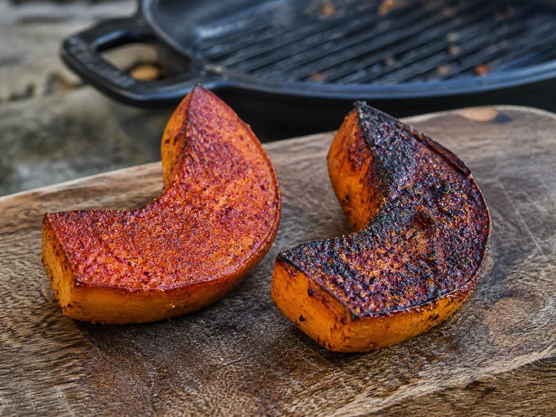 Mild red ancho-style crust beside a darker chipotle-heavy crust on seared squash - chile powder dry rub | KnowTheSpices
