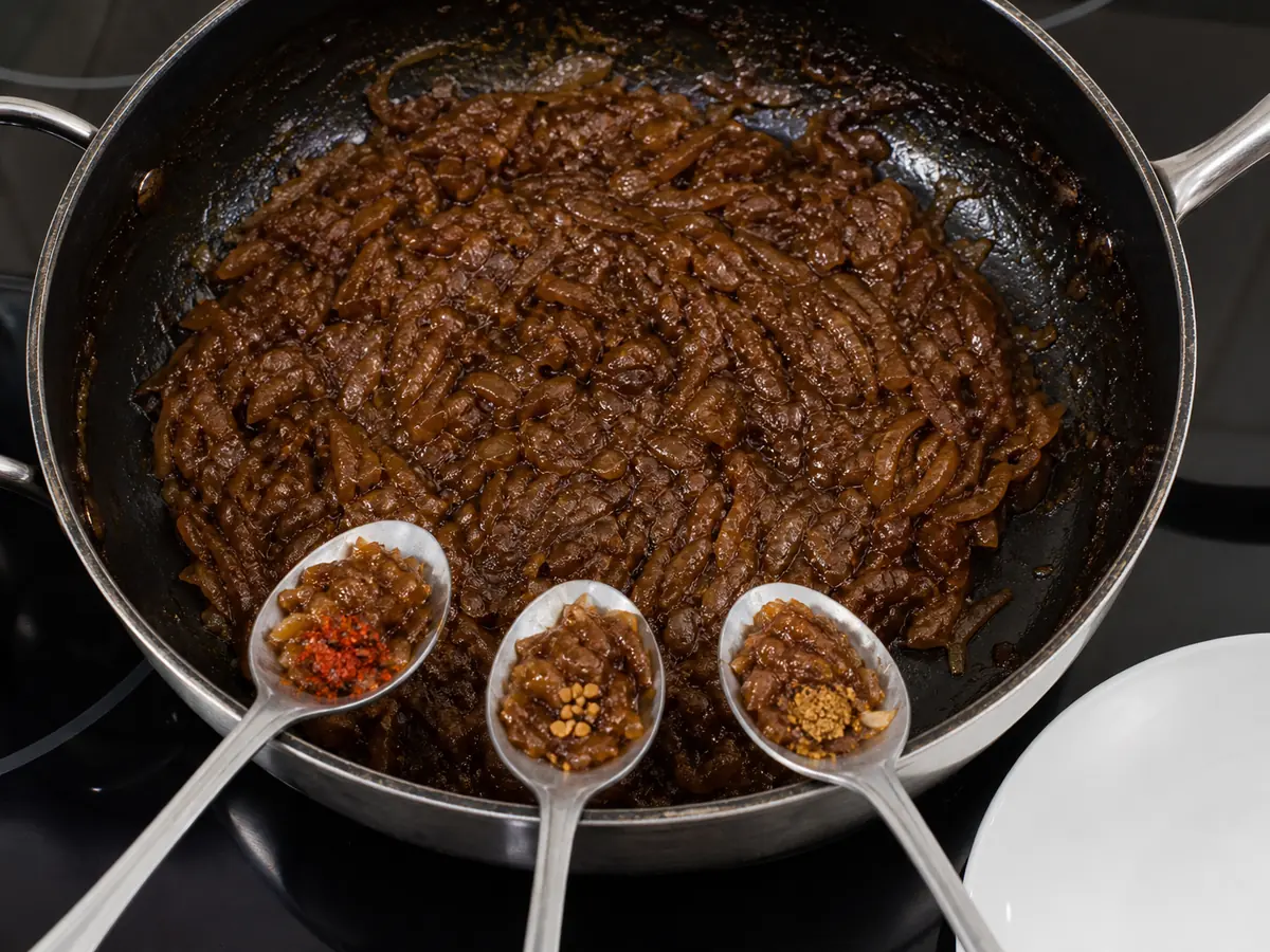 Three spoon samples of cooked onions with chile, fenugreek, and warm spice corrections - testing a berbere substitute | KnowTheSpices