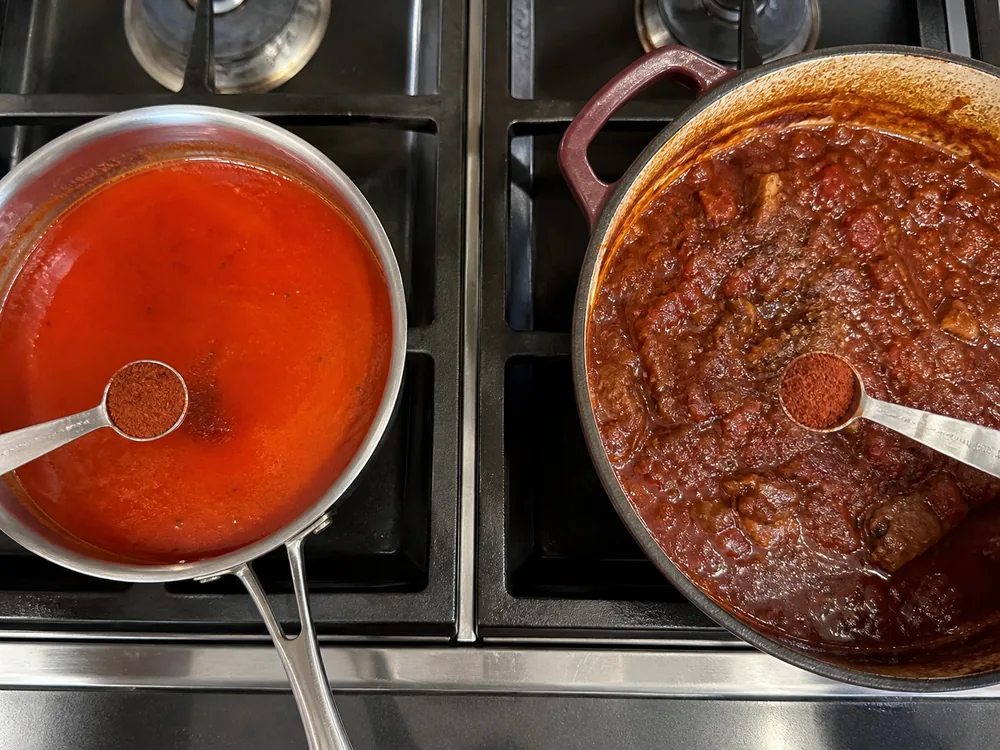 Measured chile powder added to a thin hot sauce and a thick reducing braise - cayenne substitute timing | KnowTheSpices