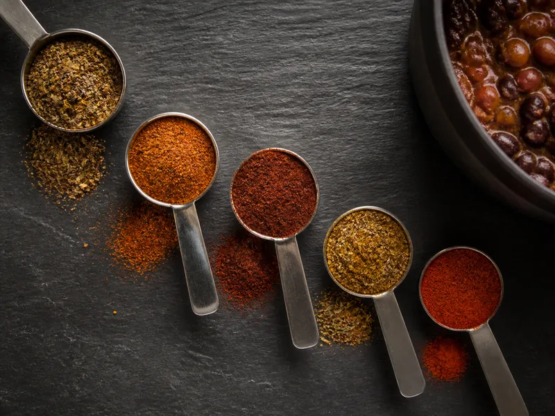 Measured ancho, cumin, oregano, paprika, cayenne, chipotle, and taco seasoning - chili powder substitutes | KnowTheSpices