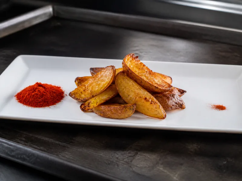 Roasted potato wedges with measured smoked paprika and a tiny cayenne pinch - chili-powder-substitutes | KnowTheSpices