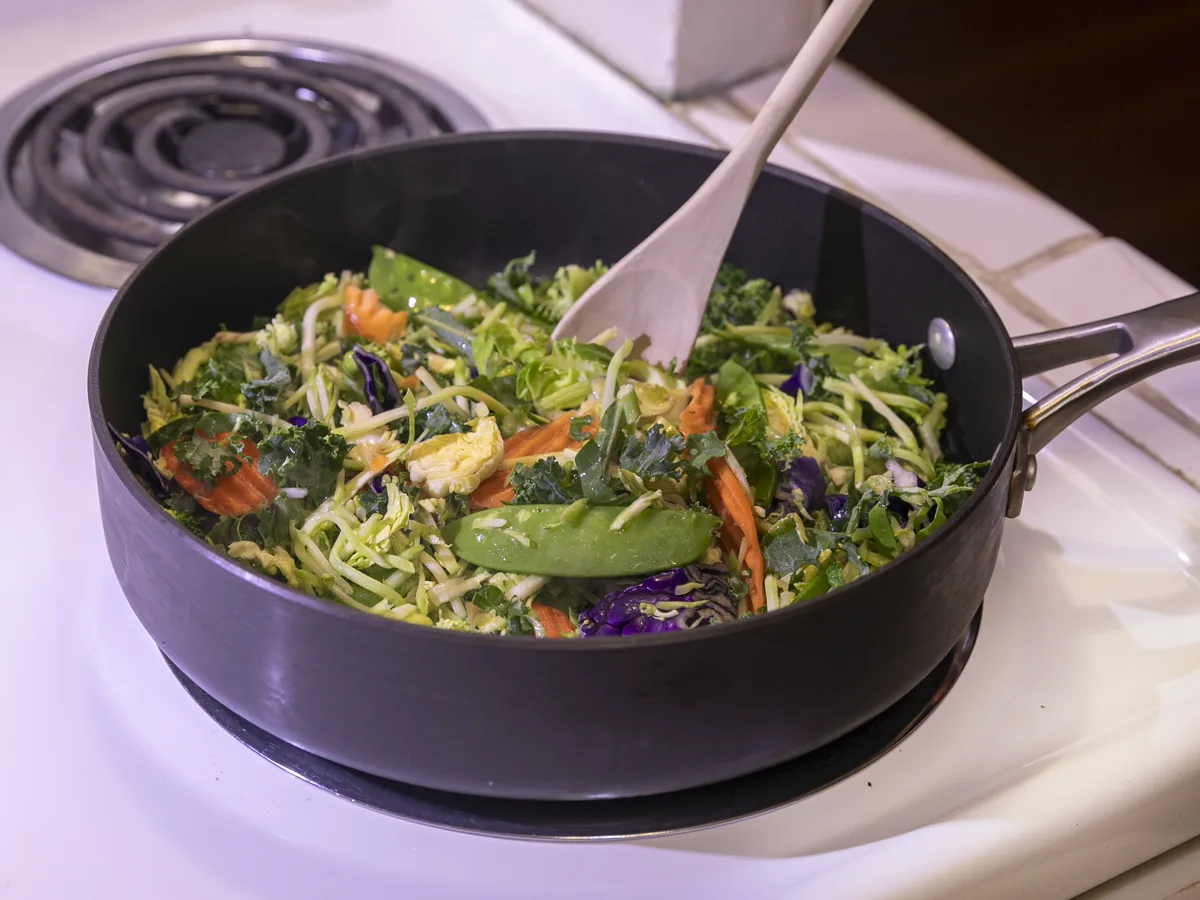 Mixed vegetables being stirred in a shallow pan - adding a Chinese five-spice substitute to a fast stir-fry | KnowTheSpices