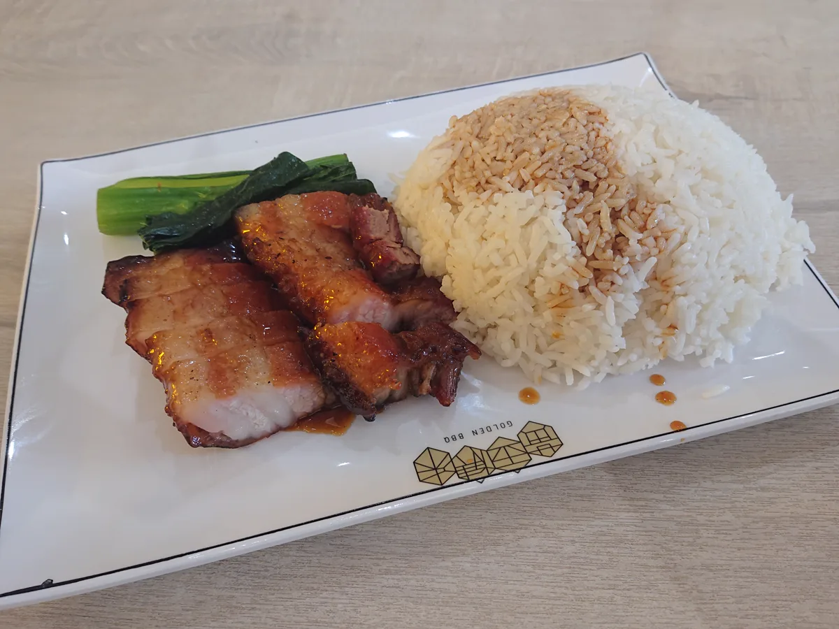 Glossy char siu beside rice showing sauce concentrated on a browned surface - five-spice substitute dosage | KnowTheSpices