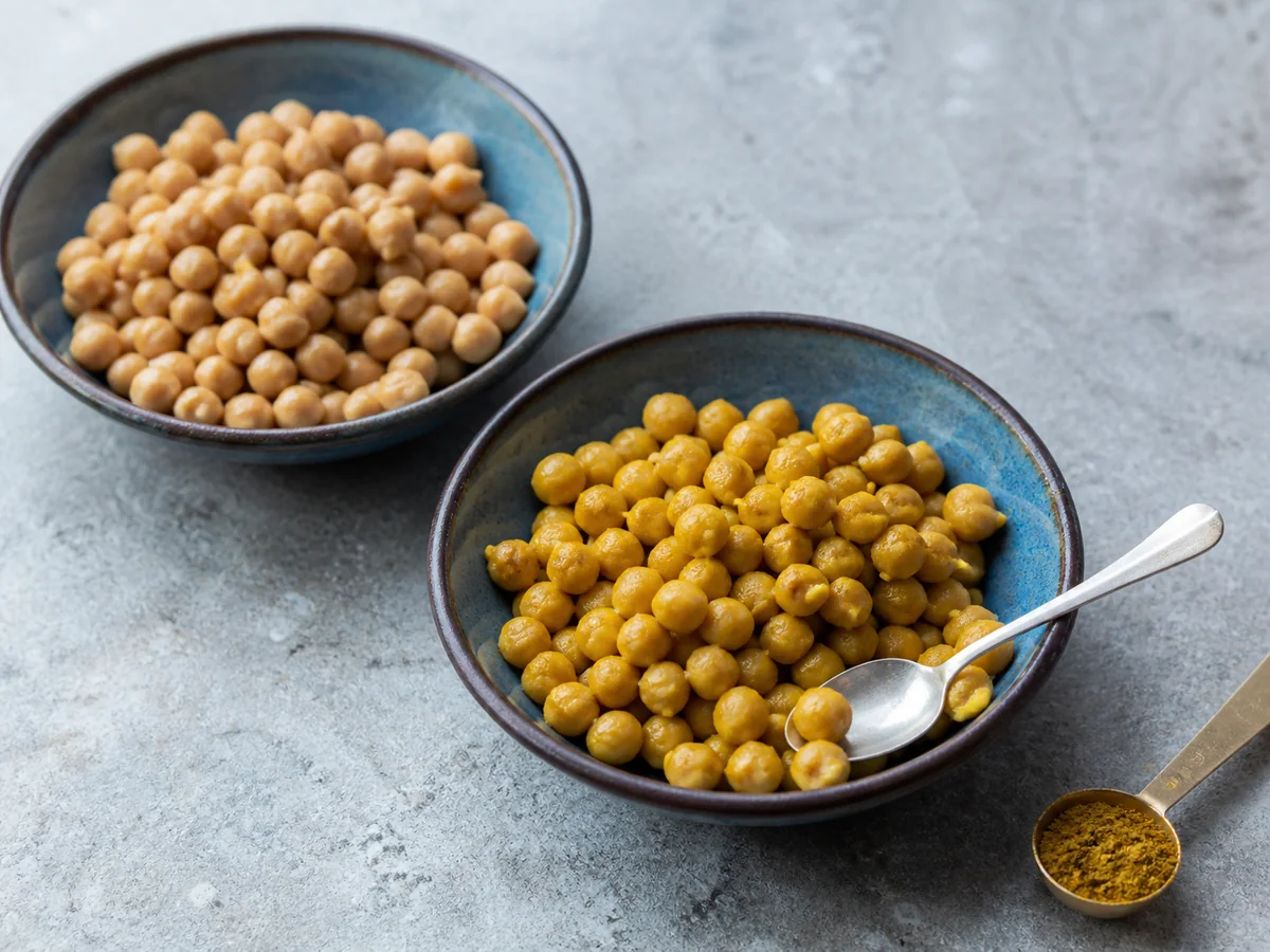 Plain chickpeas beside golden curry-seasoned chickpeas - curry powder as a cumin substitute | KnowTheSpices