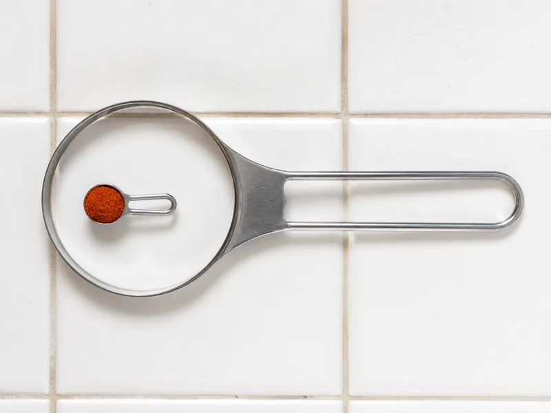 A quarter teaspoon cayenne inside a much larger tablespoon measure - gochugaru substitutes | KnowTheSpices