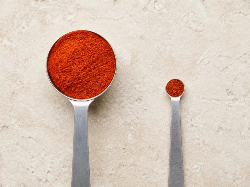 One tablespoon sweet paprika beside a quarter teaspoon cayenne - gochugaru substitutes | KnowTheSpices