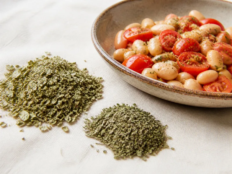 Marjoram and oregano beside white beans and tomatoes - herbs de Provence substitutes | KnowTheSpices