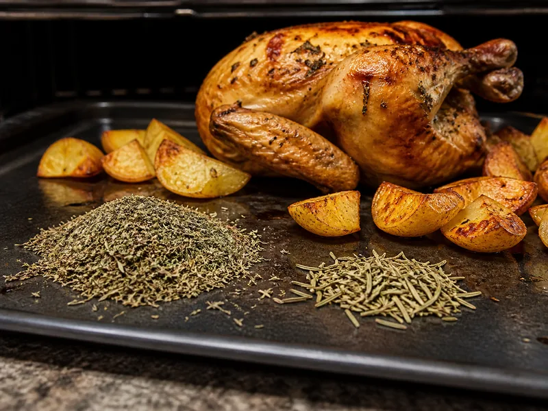 More thyme and less crushed rosemary beside roast chicken and potatoes - herbs de Provence substitutes | KnowTheSpices