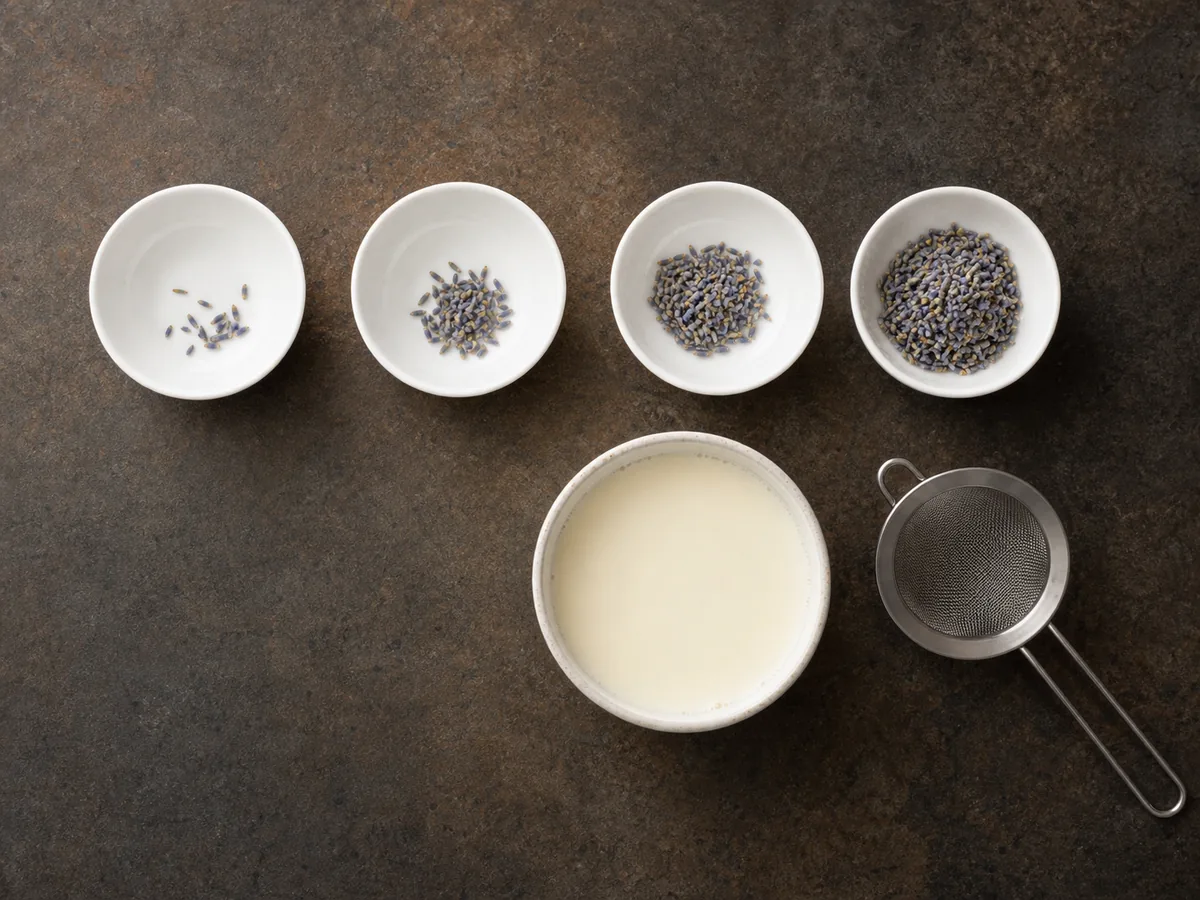Four small bowls with increasing amounts of dried lavender beside cream and a strainer - lavender dose scale | KnowTheSpices