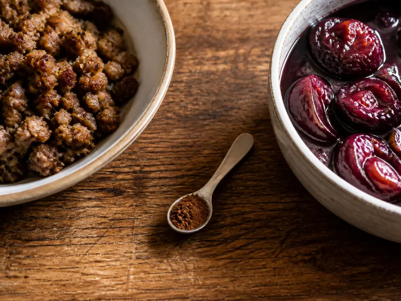 Small allspice measure beside browned meat filling and dark plum compote - Mace substitutes | KnowTheSpices