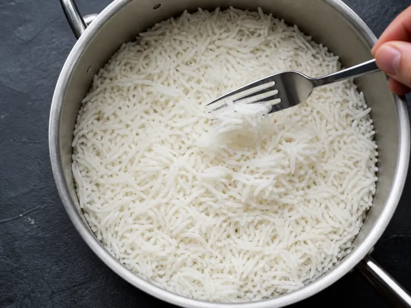 Long separate basmati grains with steam holes and a dry pot surface - steamed basmati endpoint | KnowTheSpices