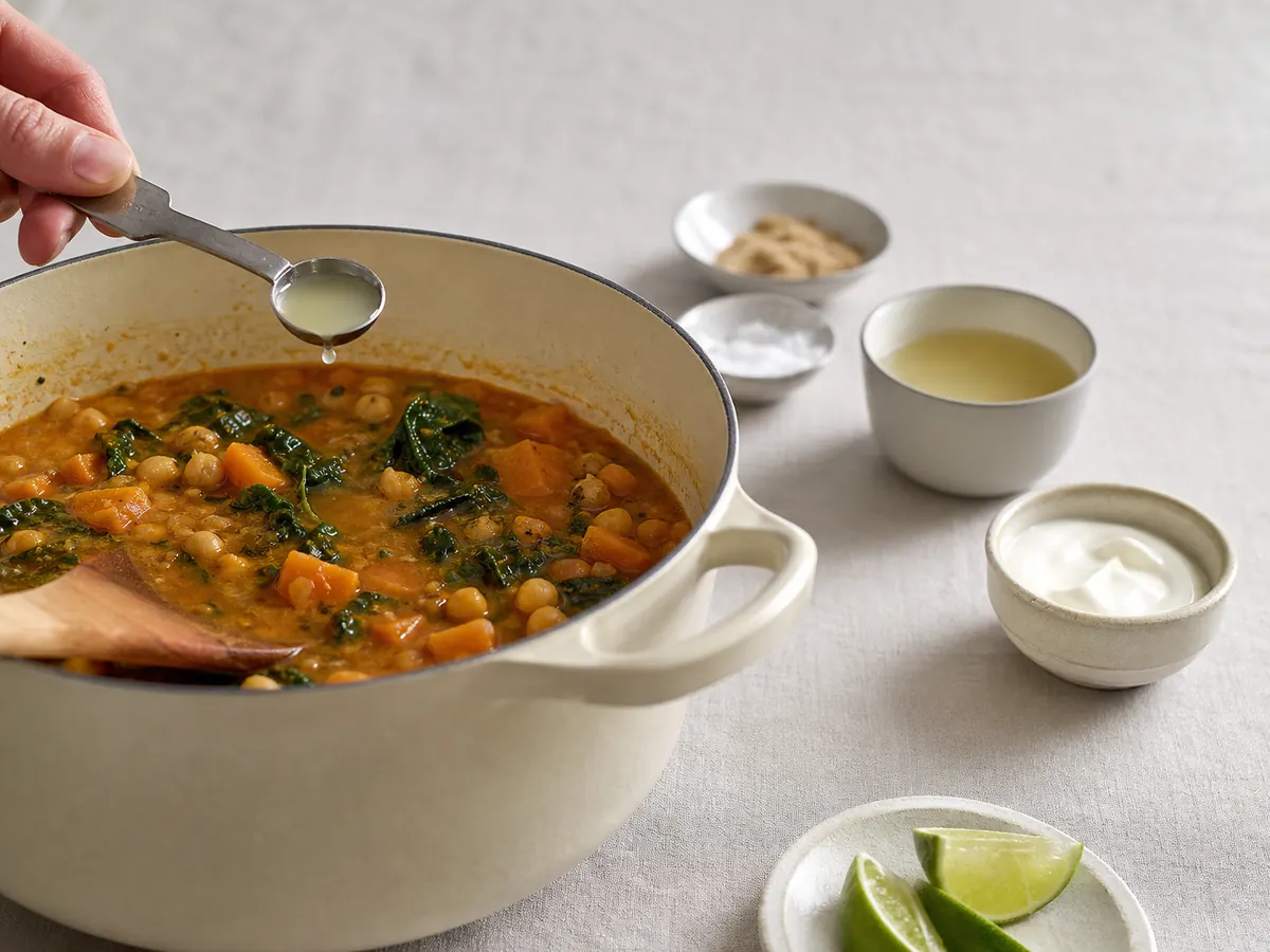 Measured lime juice added to stew with later correction ingredients waiting - flavor balancing | KnowTheSpices