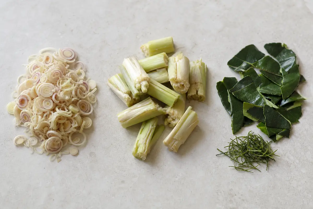 Trimmed lemongrass core bruised stalk and deveined makrut lime leaves prepared for Thai cooking - using lemongrass and makrut lime | KnowTheSpices